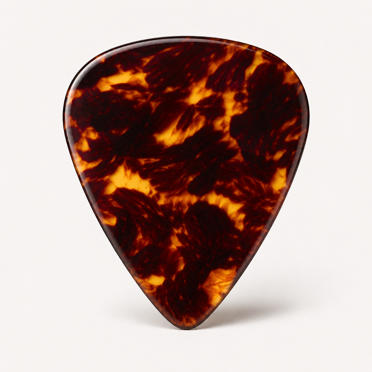 Celluloid guitar pick with tortoise-style pattern